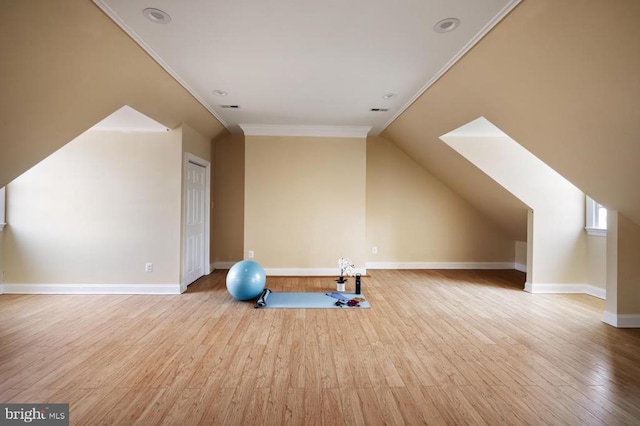  - exercise room with wood finished floors, crown molding, and vaulted ceiling