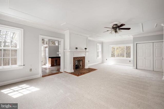  - unfurnished living room featuring carpet, crown molding, ceiling fan, and a fireplace