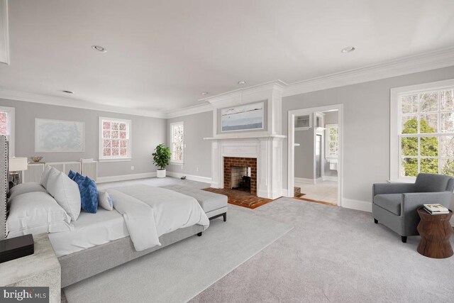  - carpeted bedroom featuring ornamental molding, a fireplace with flush hearth, ensuite bath, and recessed lighting