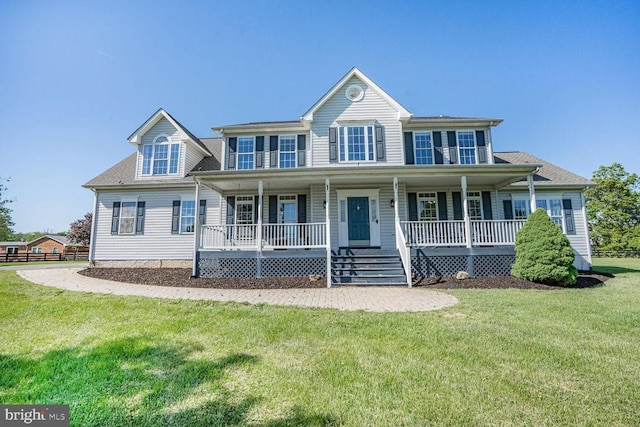 - view of front of house with a front yard, a porch, and a shingled roof