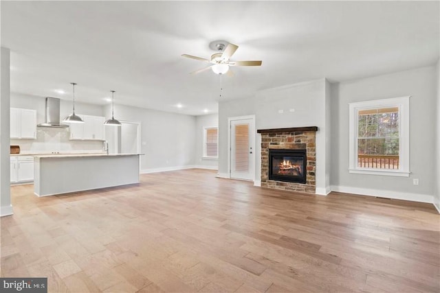Glenmore Ln Lot 37, Keswick, VA 22947 - unfurnished living room featuring a ceiling fan, light wood-type flooring, baseboards, a stone fireplace, and recessed lighting