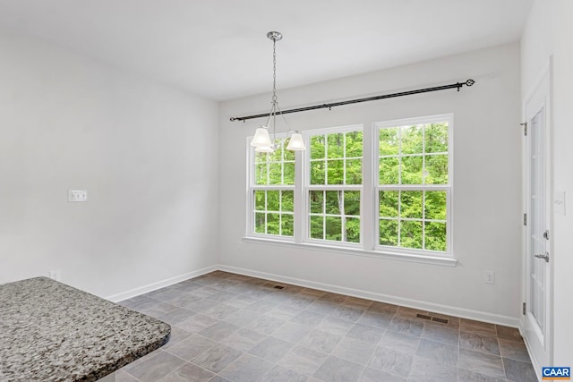 281 Manor Blvd, Palmyra, VA 22963 - unfurnished dining area with healthy amount of natural light, baseboards, and stone finish flooring