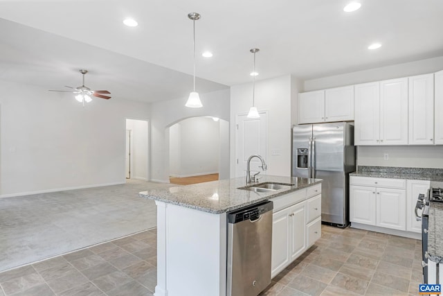281 Manor Blvd, Palmyra, VA 22963 - kitchen featuring stainless steel appliances, a sink, arched walkways, ceiling fan, and light stone countertops