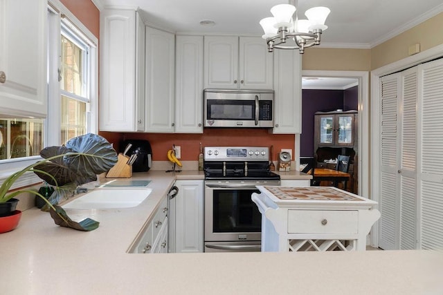 935 Glenwood Blvd, Waynesboro, VA 22980 - kitchen featuring stainless steel appliances, light countertops, white cabinetry, a chandelier, and ornamental molding