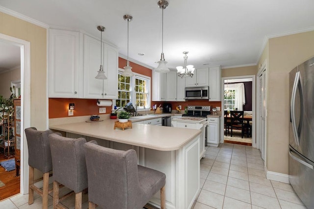 935 Glenwood Blvd, Waynesboro, VA 22980 - kitchen featuring appliances with stainless steel finishes, a chandelier, a peninsula, ornamental molding, and light countertops