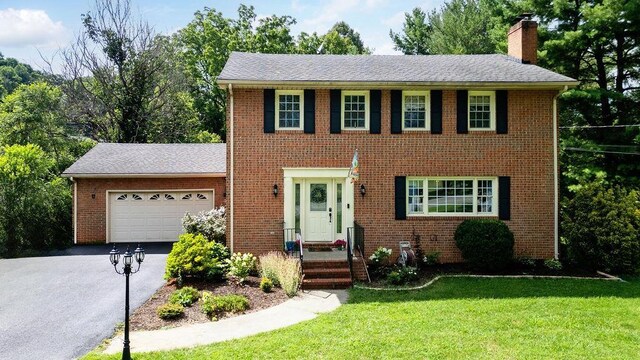 935 Glenwood Blvd, Waynesboro, VA 22980 - colonial house with a chimney, asphalt driveway, an attached garage, brick siding, and a front yard