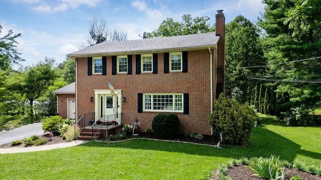 935 Glenwood Blvd, Waynesboro, VA 22980 - colonial-style house with a chimney, a front yard, and brick siding