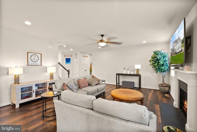 11405 Owls Nest Ct, Spotsylvania, VA 22551 - living area with dark wood finished floors, a warm lit fireplace, recessed lighting, stairway, and a ceiling fan