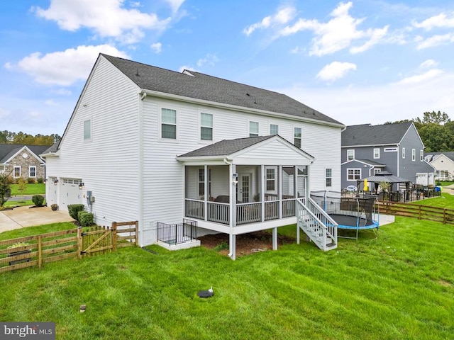 11405 Owls Nest Ct, Spotsylvania, VA 22551 - back of property featuring a sunroom, an attached garage, concrete driveway, a gate, and a trampoline