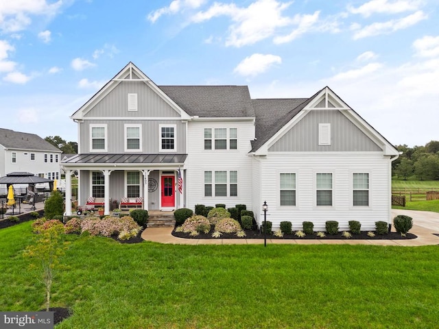 11405 Owls Nest Ct, Spotsylvania, VA 22551 - view of front of house with board and batten siding, a porch, and a front lawn