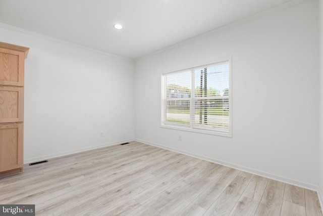 spare room featuring crown molding, light wood-type flooring, recessed lighting, and baseboards