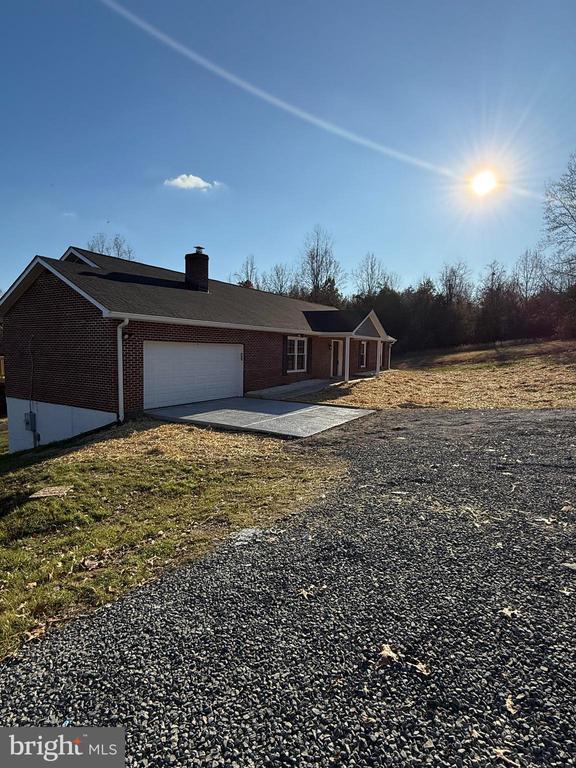 19196 Ferguson Ln, Jeffersonton, VA 22724 - single story home with an attached garage, a chimney, brick siding, and driveway