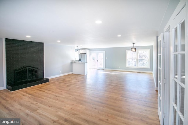 19196 Ferguson Ln, Jeffersonton, VA 22724 - unfurnished living room featuring light wood-type flooring, baseboards, a brick fireplace, and recessed lighting