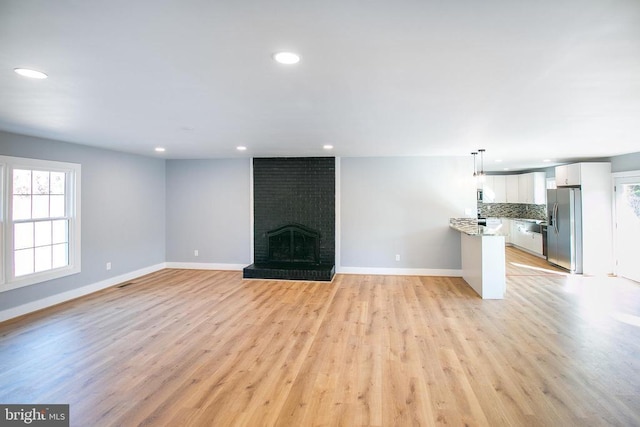 19196 Ferguson Ln, Jeffersonton, VA 22724 - unfurnished living room featuring light wood-style floors, baseboards, a brick fireplace, and recessed lighting