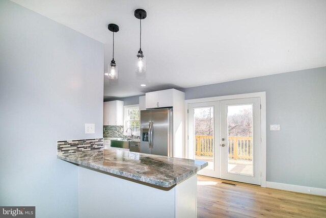 19196 Ferguson Ln, Jeffersonton, VA 22724 - kitchen featuring stone counters, french doors, white cabinetry, decorative backsplash, and stainless steel appliances