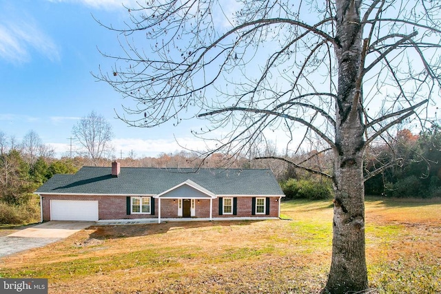 19196 Ferguson Ln, Jeffersonton, VA 22724 - ranch-style home featuring driveway, brick siding, covered porch, a garage, and a front lawn