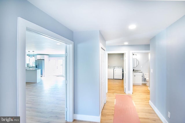 19196 Ferguson Ln, Jeffersonton, VA 22724 - hallway with independent washer and dryer, light wood-style flooring, baseboards, and recessed lighting