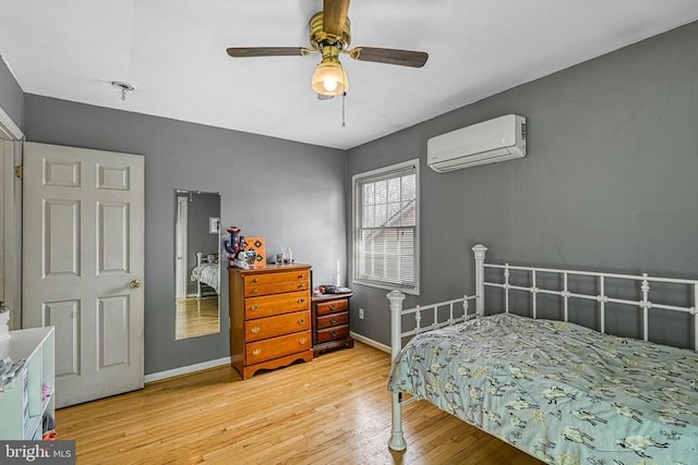 119 Birchside Cir, Locust Grove, VA 22508 - bedroom with a wall mounted air conditioner, light wood finished floors, baseboards, and ceiling fan