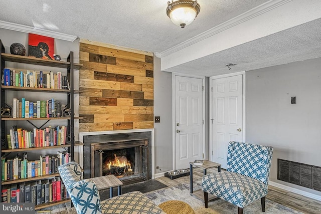 119 Birchside Cir, Locust Grove, VA 22508 - living area featuring a textured ceiling, ornamental molding, wood finished floors, a fireplace with flush hearth, and wood walls