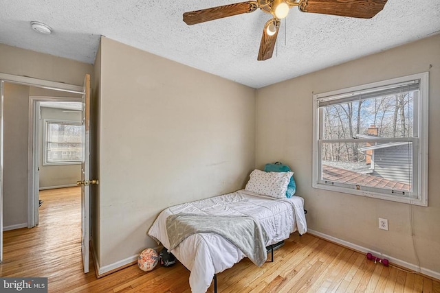 119 Birchside Cir, Locust Grove, VA 22508 - bedroom featuring baseboards, light wood-style floors, a textured ceiling, and a ceiling fan