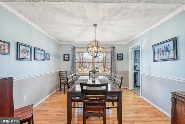 119 Birchside Cir, Locust Grove, VA 22508 - dining space featuring a chandelier, light wood finished floors, a textured ceiling, ornamental molding, and baseboards