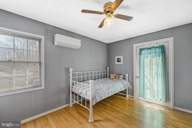 119 Birchside Cir, Locust Grove, VA 22508 - bedroom with a wall mounted air conditioner, wood finished floors, baseboards, and a ceiling fan