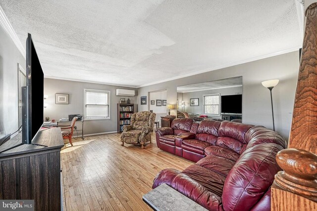 119 Birchside Cir, Locust Grove, VA 22508 - living room with a textured ceiling, an AC wall unit, crown molding, wood-type flooring, and baseboards