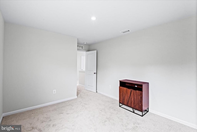 spare room featuring carpet floors, baseboards, and recessed lighting