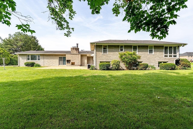 4490 N Valley Pike, Rockingham, VA 22802 - back of property with stone siding, a lawn, a chimney, and a patio area