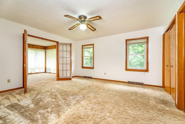 4490 N Valley Pike, Rockingham, VA 22802 - empty room featuring carpet floors, healthy amount of natural light, ceiling fan, and a textured ceiling