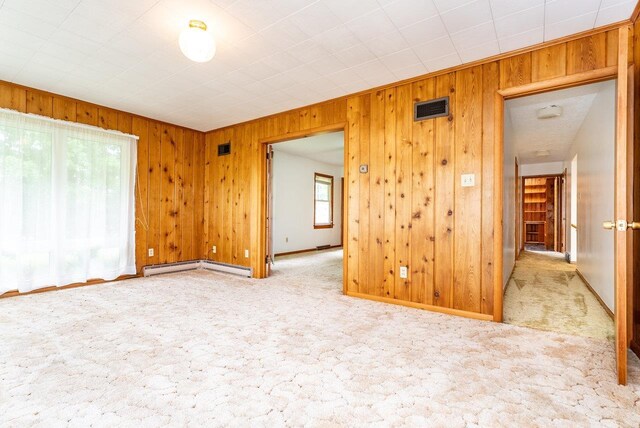 4490 N Valley Pike, Rockingham, VA 22802 - unfurnished room featuring wood walls, carpet floors, and baseboard heating