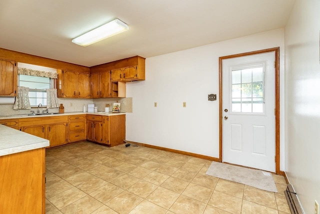 4490 N Valley Pike, Rockingham, VA 22802 - kitchen with brown cabinets, light countertops, tasteful backsplash, and light tile patterned floors