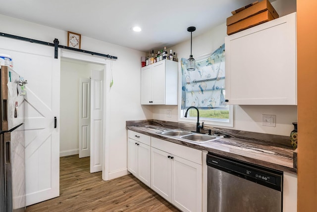 250 Washington Ave W, Elkton, VA 22827 - kitchen with stainless steel appliances, a sink, a barn door, light wood-type flooring, and white cabinetry