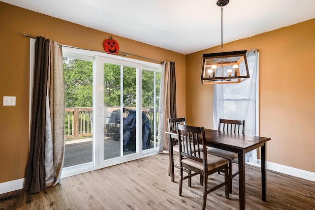 250 Washington Ave W, Elkton, VA 22827 - dining room with baseboards, a chandelier, wood finished floors, and lofted ceiling