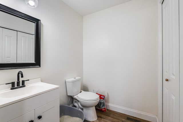 250 Washington Ave W, Elkton, VA 22827 - half bath with wood finished floors, baseboards, toilet, vanity, and a closet