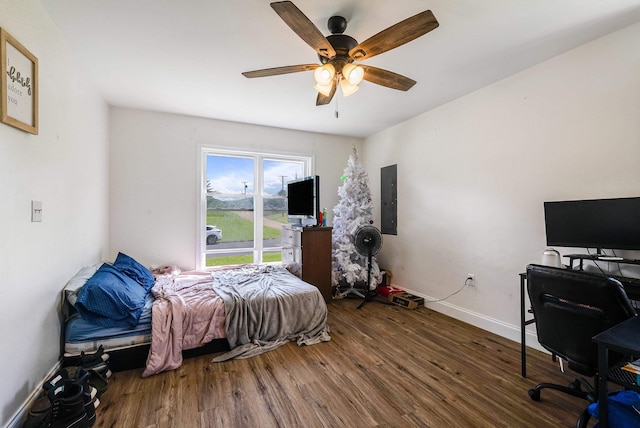 250 Washington Ave W, Elkton, VA 22827 - bedroom with wood finished floors, a desk, electric panel, and baseboards