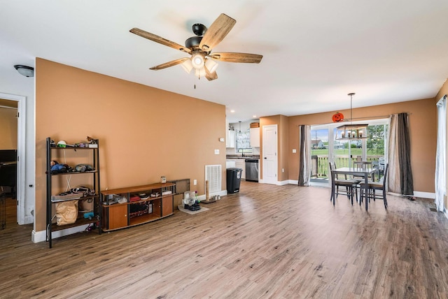 250 Washington Ave W, Elkton, VA 22827 - living room featuring wood finished floors, a ceiling fan, and baseboards