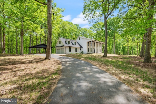  - colonial inspired home featuring driveway, a garage, and a carport