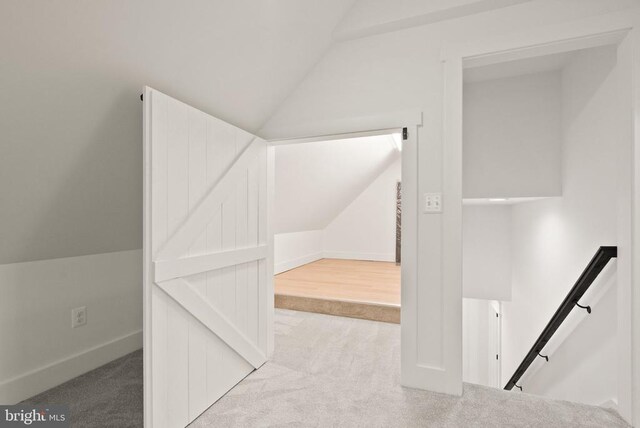  - additional living space with carpet flooring, baseboards, and lofted ceiling