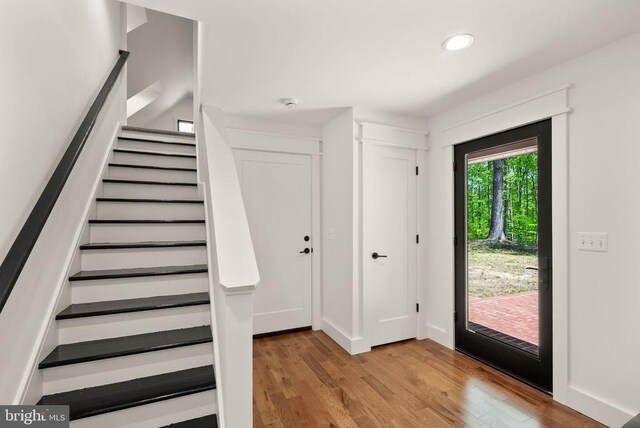  - foyer entrance featuring stairway, wood finished floors, baseboards, and recessed lighting