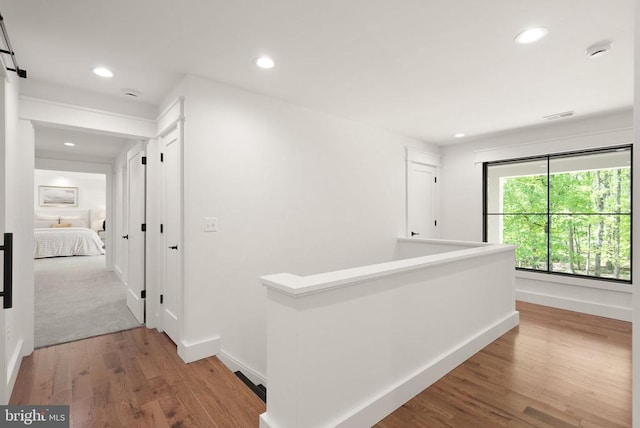  - hallway featuring baseboards, an upstairs landing, recessed lighting, and wood finished floors