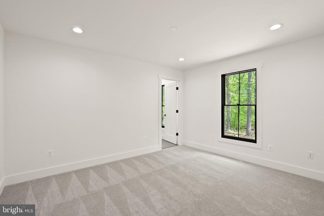  - empty room with carpet floors, baseboards, and recessed lighting