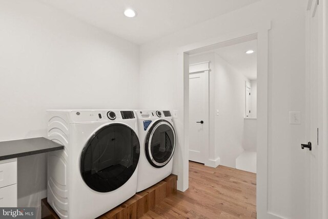  - laundry area featuring separate washer and dryer, laundry area, light wood finished floors, and recessed lighting