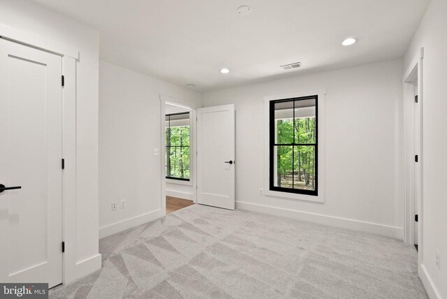  - unfurnished bedroom featuring recessed lighting, visible vents, baseboards, and carpet floors
