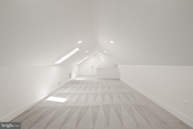  - bonus room with baseboards, light carpet, recessed lighting, and vaulted ceiling with skylight