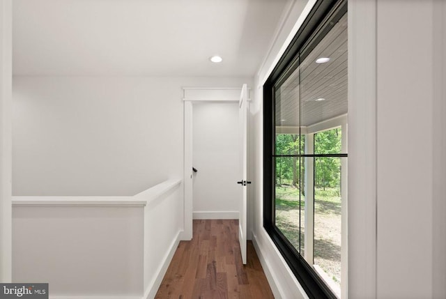  - corridor featuring wood finished floors, baseboards, and recessed lighting