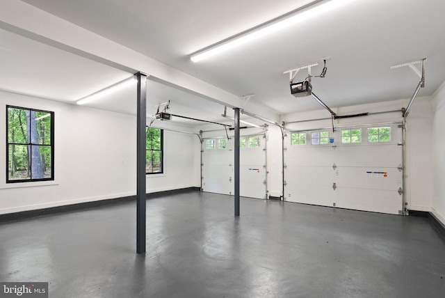  - garage featuring baseboards and a garage door opener