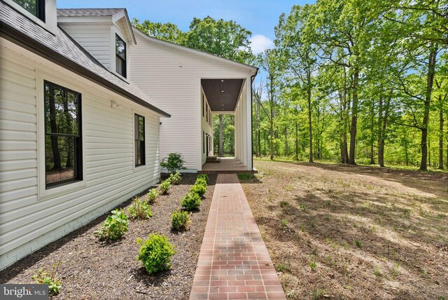  - view of home's exterior with roof with shingles