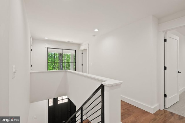  - hall featuring recessed lighting, baseboards, an upstairs landing, and wood finished floors