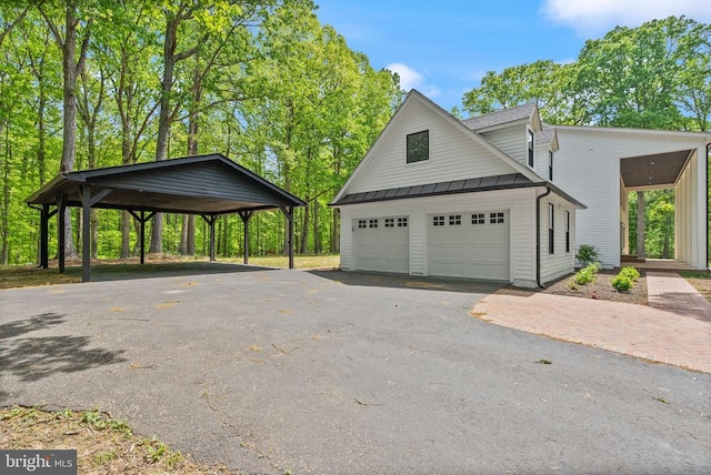  - exterior space with metal roof, aphalt driveway, and a standing seam roof